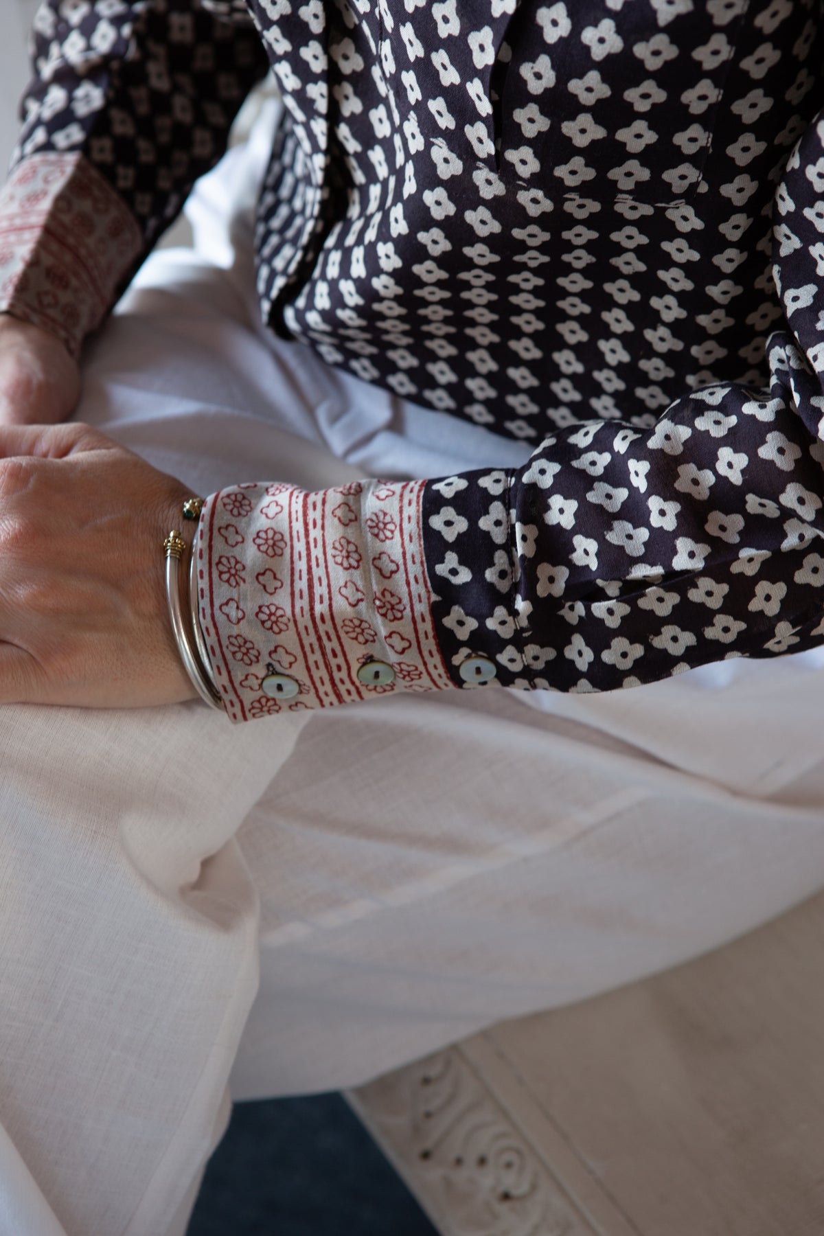 Rajmahal bangles worn at the wrist over a block-printed sleeve
